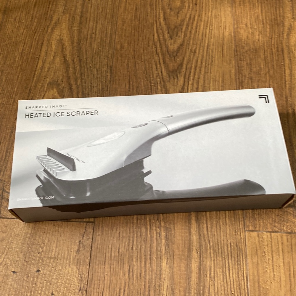Heated ice scraper